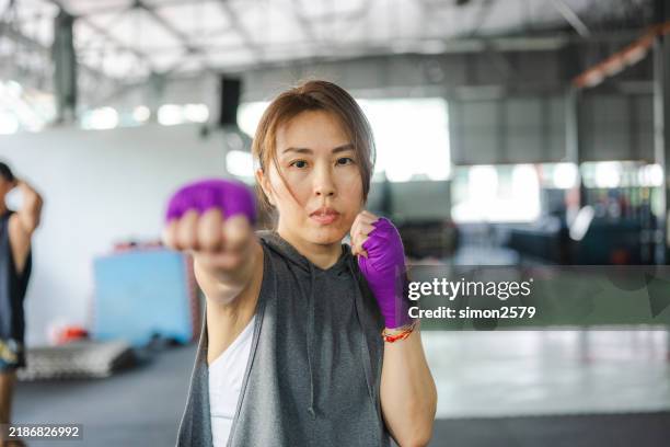 training with precision: a female fighter’s path to mastery - martial arts stock pictures, royalty-free photos & images