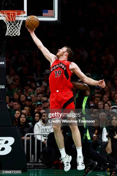 Jakob Poeltl of the Toronto Raptors grabs a rebound against the Boston Celtics during the second quarter at TD Garden on November 16, 2024 in Boston,...
