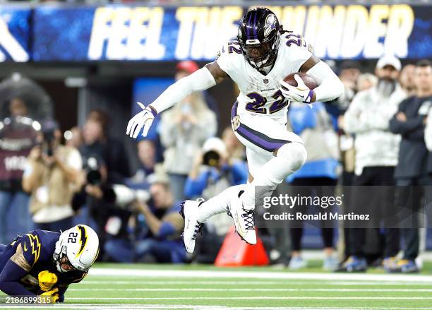 Derrick Henry of the Baltimore Ravens dodges a tackle against Elijah Molden of the Los Angeles Chargers during the third quarter in the game at SoFi...
