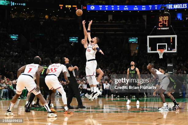 Kristaps Porzingis of the Boston Celtics and Ivica Zubac of the LA Clippers jump for the ball during the first quarter at the TD Garden on November...