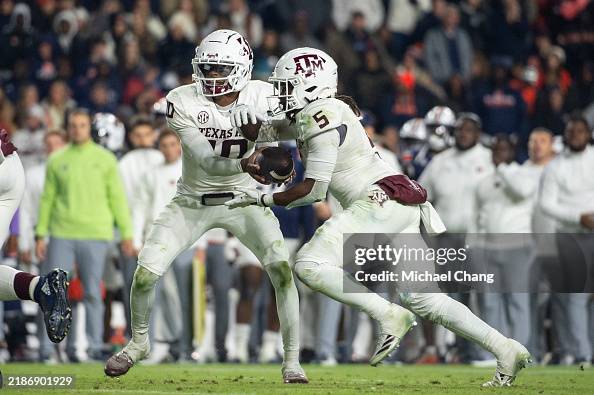 Marcel Reed Action Quarterback Marcel Reed of the Texas A&M Aggies looks to hand the ...