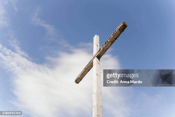 wooden summit cross at säuling from below against blue sky wiht some clouds - crucifix stock pictures, royalty-free photos & images