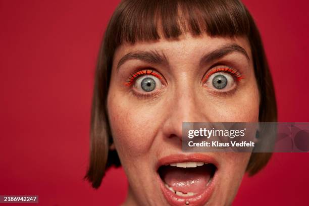 portrait of surprised woman with eyes wide open - facial expression stock pictures, royalty-free photos & images