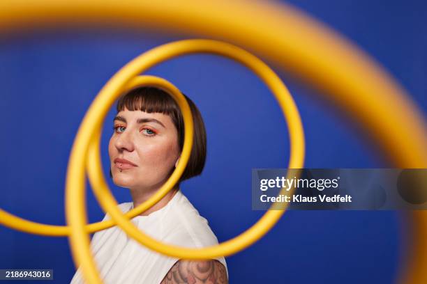 portrait of woman staring through spiral cables - side view stock pictures, royalty-free photos & images