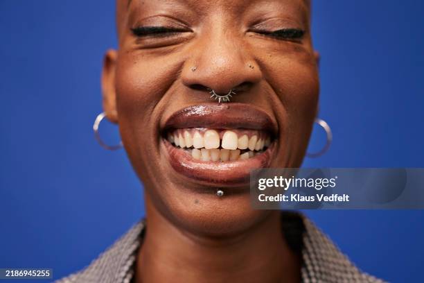 happy non-binary person with diastema - zahnlücke stock-fotos und bilder