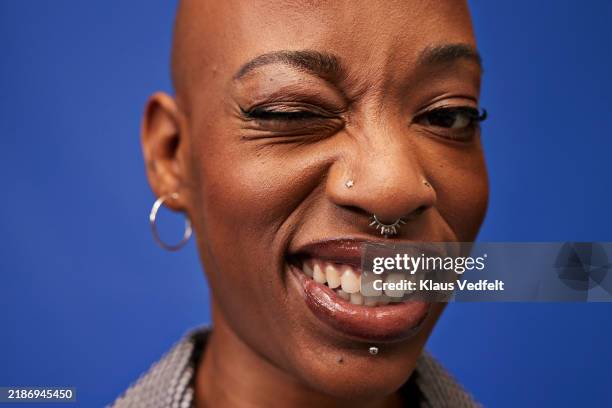 portrait of happy non-binary person winking - wrinkled stock pictures, royalty-free photos & images