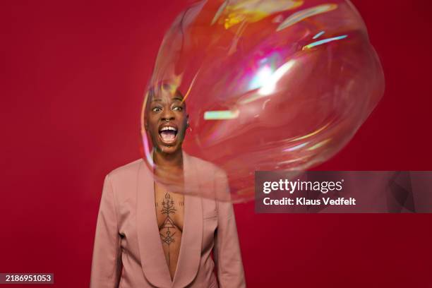 non-binary person screaming at bubble - enlarged spleen stock pictures, royalty-free photos & images