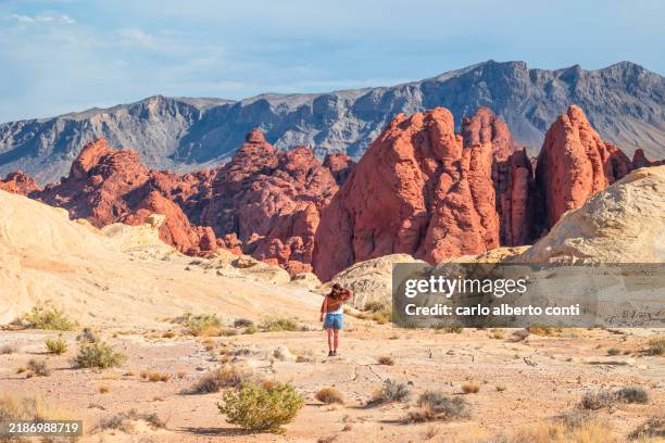 a girl admire the beautiful landscape in valley of fire state park, during a summer day, nevada, united state of america - nevada stock pictures, royalty-free photos & images