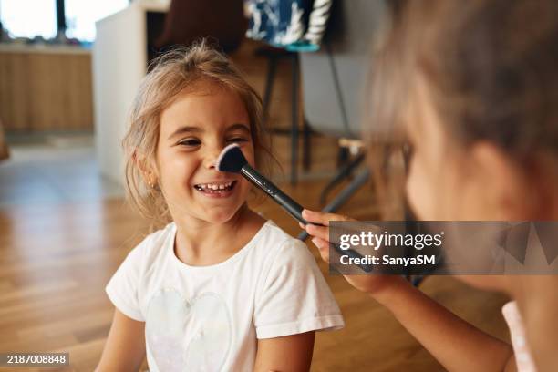 sisters taking care of their look - painting fingernails stock pictures, royalty-free photos & images