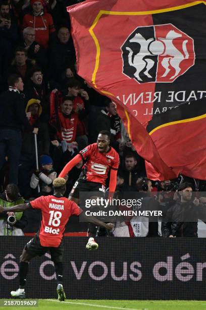Rennes' French forward Arnaud Kalimuendo celebrates scoring his team's first goal from the penalty spot with Rennes' Cameroonian defender Mahamadou...