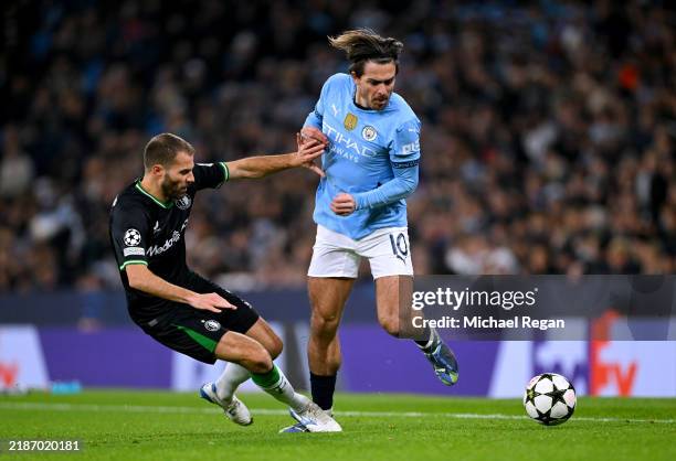 Jack Grealish of Manchester City is challenged by Bart Nieuwkoop of Feyenoord during the UEFA Champions League 2024/25 League Phase MD5 match between...