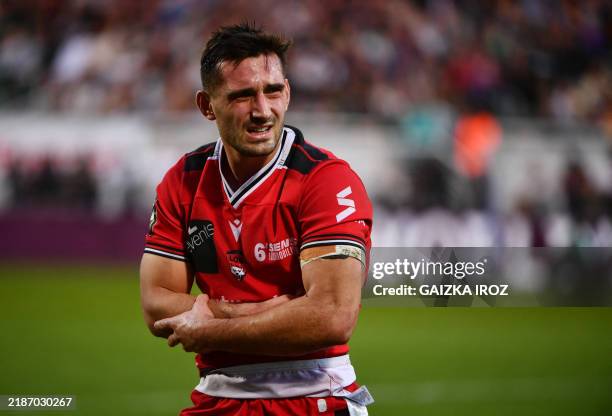 Lyon's French scrum-half Baptiste Amedee Couilloud leaves the pitch after picking up an injury during the French Top14 rugby union match between...