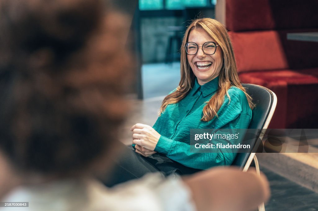 Business women in friendly conversation
