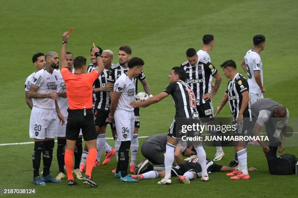Argentine referee Facundo Tello gives a red card to Botafogo's midfielder Gregore during the Copa Libertadores final football match between Brazilian...