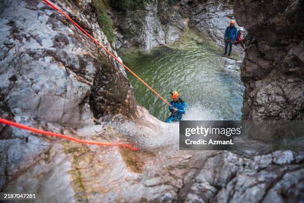 canyoning excitement with caucasian male - canyoneering stock pictures, royalty-free photos & images