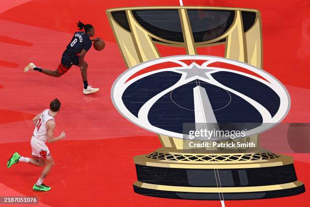 Carlton Carrington of the Washington Wizards dribbles the ball up court in front of Matas Buzelis of the Chicago Bulls during the first half in the...