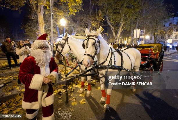 Performer dressed as Santa Claus handles a horse-drawn carriage at the opening of the Advent Zagreb Christmas market event in Zagreb, on November 30,...