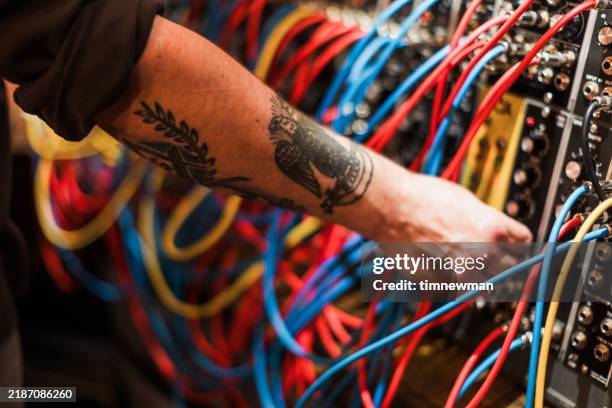 sound engineer and musician with vintage analog synth deck in sound recording studio - sound engineer stock pictures, royalty-free photos & images