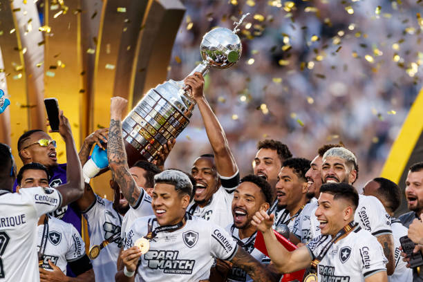 Players of Botafogo celebrate with the trophy after winning the tournament following the Copa CONMEBOL Libertadores 2024 Final between Atletico...