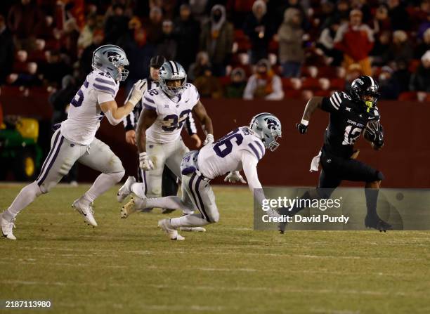 Running back Jaylon Jackson of the Iowa State Cyclones rushes for yards past linebacker Austin Romaine, linebacker Desmond Purnell, and safety Jack...
