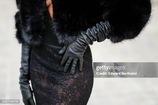 Emilie Joseph wears black leather YSL gloves, a black lace skirt, during a street style fashion photo session, on November 16, 2024 in Paris, France.