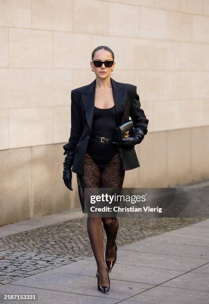 Berna Bilbey wears black bag Celine, heels Saint Laurent, belt Saint Laurent, sunglasses Saint Laurent, black laced skirt Mango, tailored blazer...