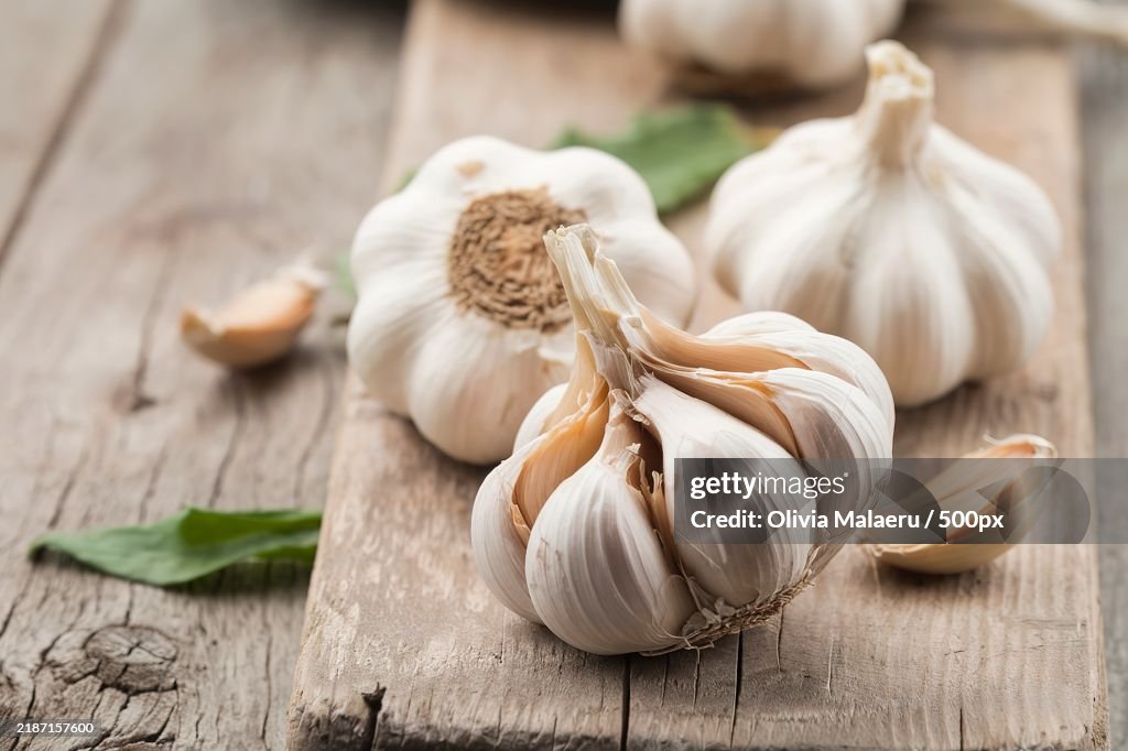 Garlic whole and cloves on a wooden rustic background