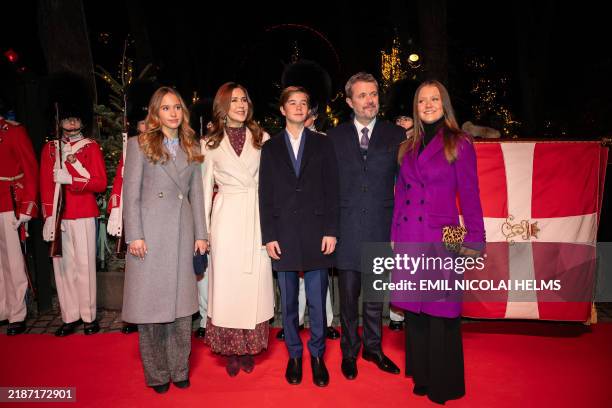 Denmark's Princess Josephine, Queen Mary, Prince Vincent, Princess Isabella, King Frederik, and Princess Isabella pose on the red carpet upon arrival...