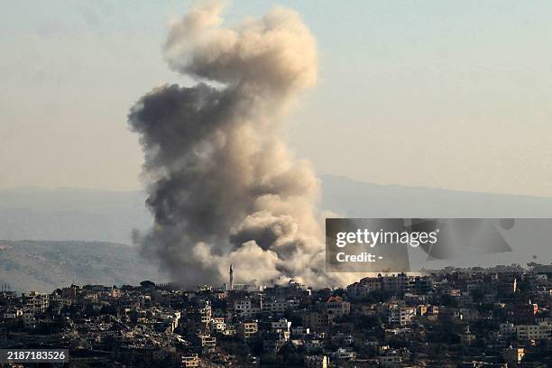In this picture taken from Marjayoun, thick smoke rises from explosions as Israeli forces reportedly demolish dwellings in the border town of Khiam...