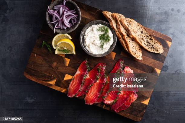 beetroot cured salmon served with horseradish cream, red onion, buckwheat bread - smoked food stock pictures, royalty-free photos & images