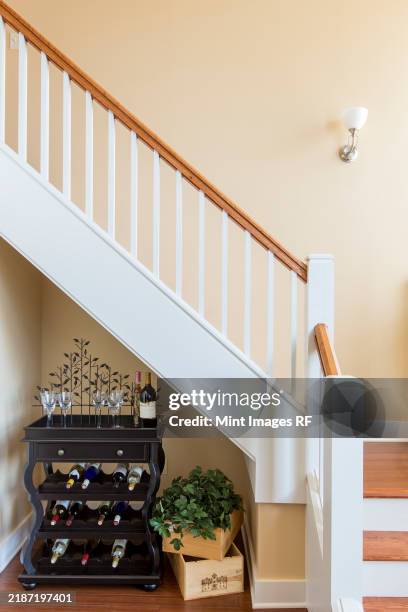 a family home interior, a wine rack under the stairs - flaschenpost stock-fotos und bilder