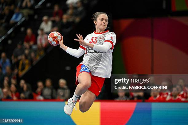Denmark's wing Emma Friis throws the ball and scores a goal during the women's EHF 2024 European championship handball game between Denmark and...
