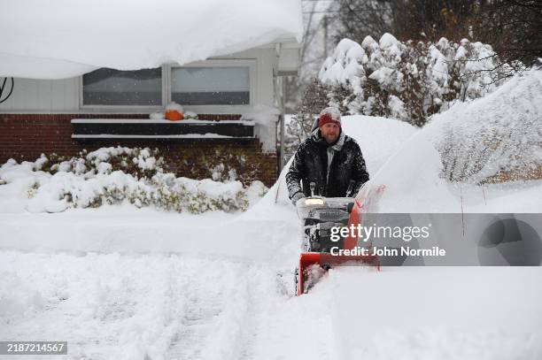 Ken Wex begins the task of removing the near two feet of lake effect snow from his home on December 1, 2024 in Hamburg, New York. The North Eastern...