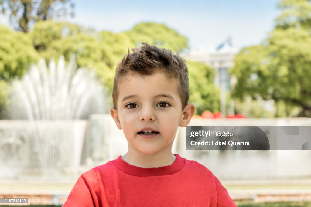 Child enjoys the outdoors in a public square in the city of Mendoza, Argentina.