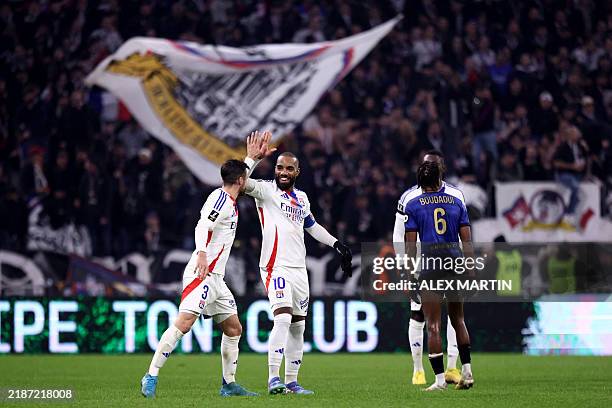 Lyon's French forward Alexandre Lacazette celebrates with Lyon's Argentine defender Nicolas Tagliafico after scoring a goal during the French L1...