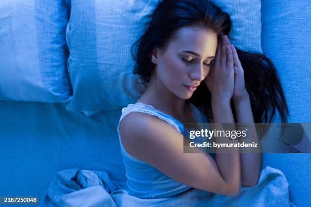 woman sleeping in bed on her left side - fresh from bed stock pictures, royalty-free photos & images