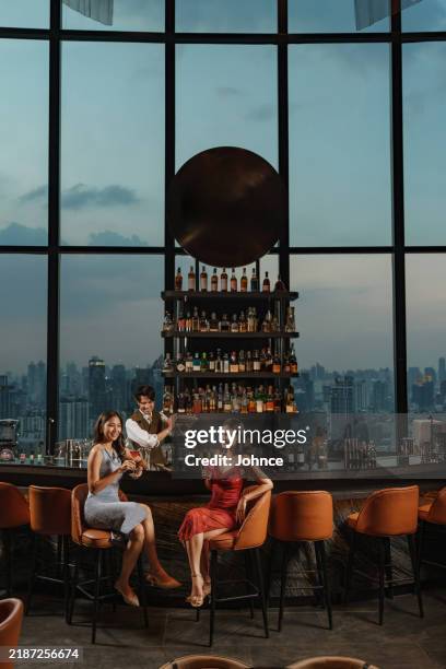 ladies' night at the rooftop bar - evening gown stock pictures, royalty-free photos & images