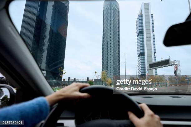 driver navigating through madrid's modern financial district, admiring the towering skyscrapers - car point of view stock pictures, royalty-free photos & images