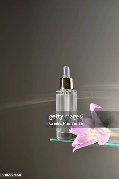 facial serum with pipette on glass shelf in bathroom. - botella con gotero fotografías e imágenes de stock