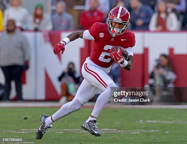 Ryan Williams of the Alabama Crimson Tide returns a punt during the first half against the Auburn Tigers at Bryant-Denny Stadium on November 30, 2024...