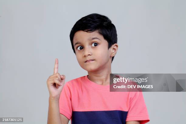 little boy showing index finger with funny expression - south asia stock pictures, royalty-free photos & images