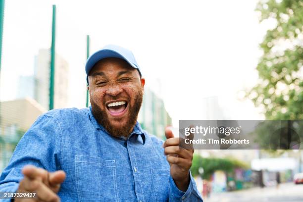 happy man being fun, playful, dancing, smiling and laughing - body conscious stock pictures, royalty-free photos & images