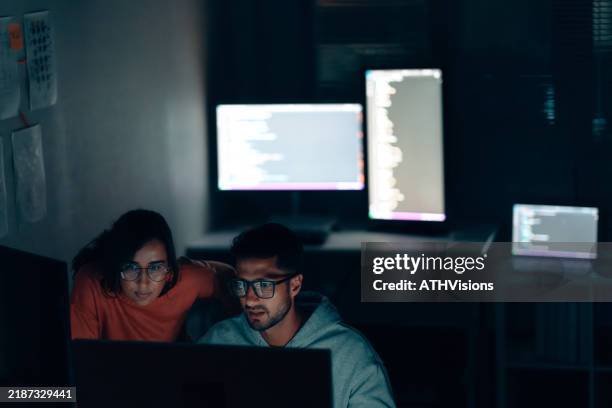 hispanic programmers collaborating on software development and data analysis in a modern office - python code stock pictures, royalty-free photos & images