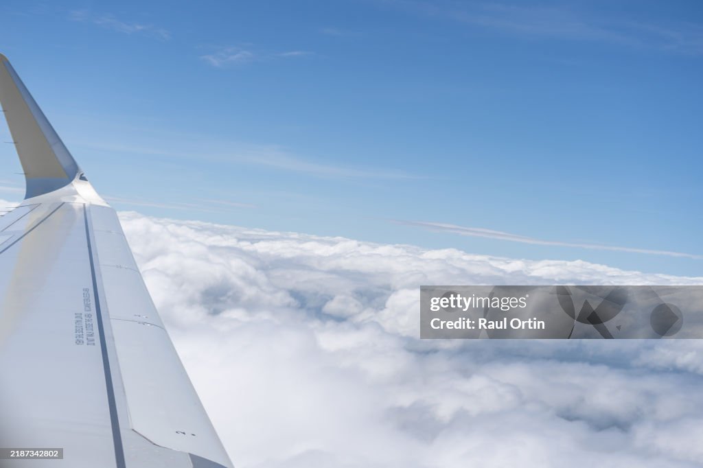 Aerial shot of blue sky with sea clouds, view from airplane