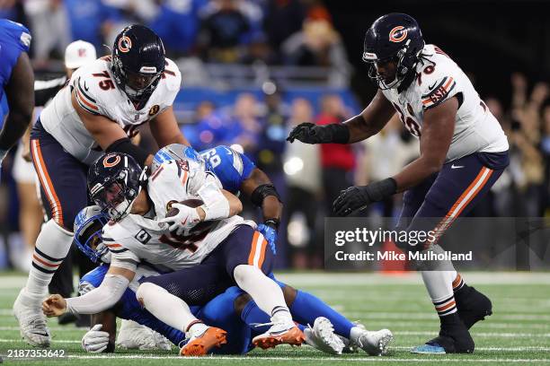 Quarterback Caleb Williams of the Chicago Bears is sacked during the fourth quarter of a game against the Detroit Lions at Ford Field on November 28,...
