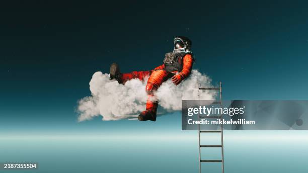 relaxation redefined: astronaut lounging on a cloud - man pretend sleep stock pictures, royalty-free photos & images