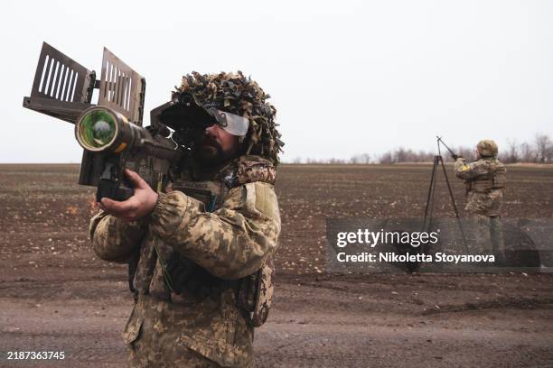 Machine gunner with the 118th Separate Mechanized Brigade's firing team holds an American FIM-92 Stinger man-portable air defense missile system for...