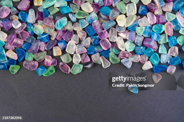 many different kinds of colorful minerals and semi precious gems. on black background. - aventurine stock pictures, royalty-free photos & images