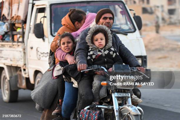 Displaced Syrian Kurds drive vehicles on the Aleppo-Raqqa highway to flee areas on the outskirts of the northern city of Aleppo which were formerly...