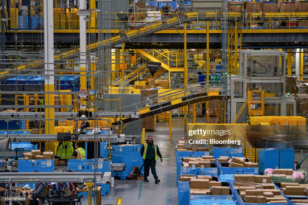 Workers prepare packages for shipping at an Amazon Fulfillment center ...